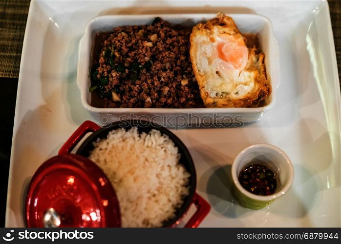 Stir fried beef with basil and steamed rice and fried egg