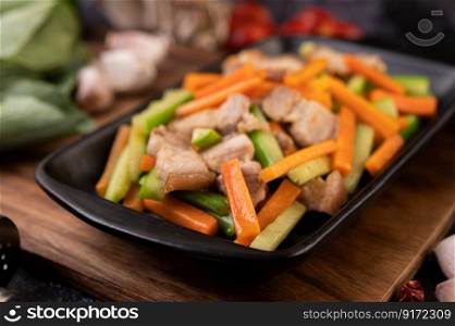 Stir-fried carrots and cucumber with pork belly.