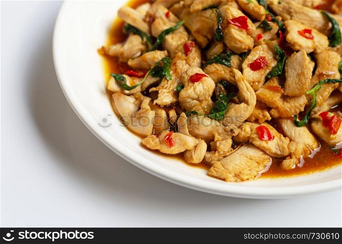 Stir-fried chicken with holy basil on white background.
