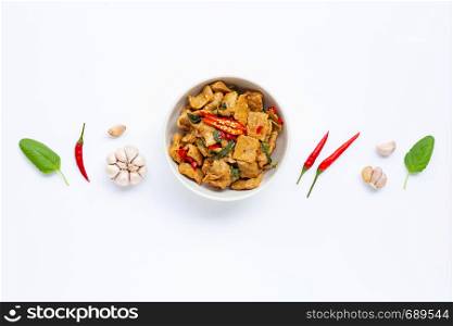 Stir-fried hot and spicy pork with basil on white background.