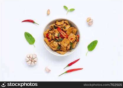 Stir-fried hot and spicy pork with basil on white background.