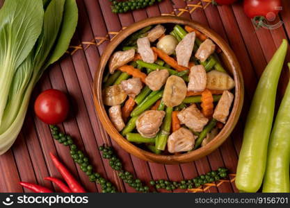 Stir-fried mixed vegetables containing Green peas, carrots, mushrooms, corn, broccoli, and pork.