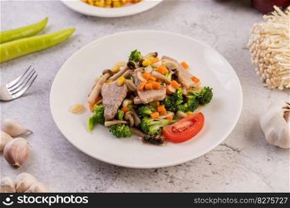 Stir-fried mixed vegetables with pork in a white plate
