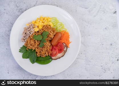 Stir-fried noodles with minced pork, edamame, tomatoes and mushrooms in a white plate.