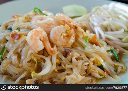 Stir fried noodles with shrimp , egg and fresh vegetable on dish