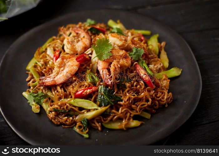 Stir fried noodles with shrimps and vegetables. 