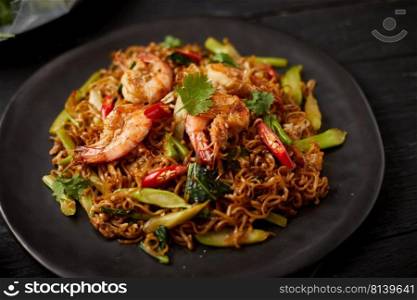 Stir fried noodles with shrimps and vegetables. 
