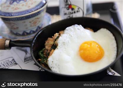 Stir fried pork and basil served with rice and fried egg , Thai food