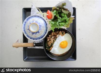 Stir fried pork and basil served with rice and fried egg , Thai food