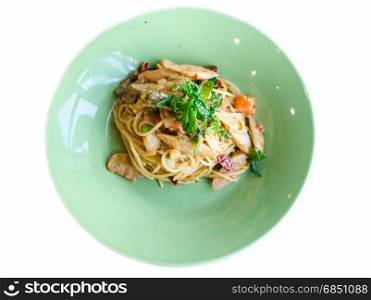 stir-fried spicy spaghetti with sausage and basil on white background