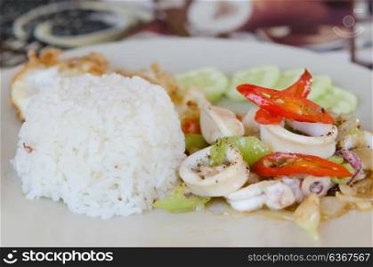 stir fried squid and vegetable served with steamed rice , spicy food