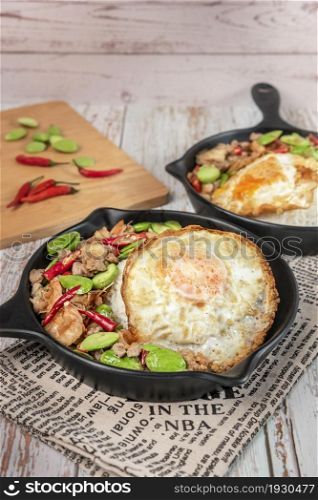 Stir-Fried Twisted Cluster Bean with Shrimps/Butter Bean and fried egg on top , Thai spicy dishes. Stir-Fried Twisted Cluster Bean with Shrimps