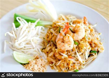 Stir fry noodles with shrimp , egg and fresh vegetable on white dish
