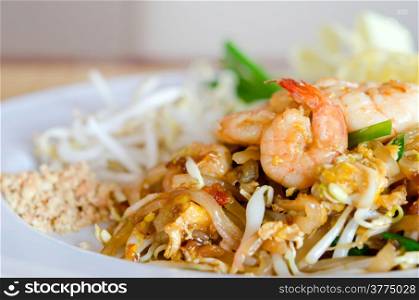 Stir fry noodles with shrimp , egg and vegetable on white dish