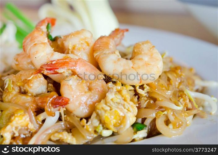 Stir fry noodles with shrimp , egg and vegetable on white plate