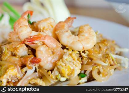 Stir fry noodles with shrimp , egg and vegetable on white plate
