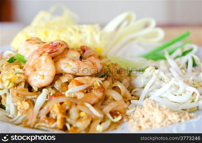 Stir fry noodles with shrimp , egg served with fresh vegetable