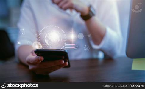 Stock exchange market concept, hand trader holding smartphone with graphs analysis candle line on bokeh colors light in night.