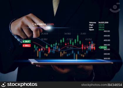 Stock market chart business using a tablet to analyze online trading data.Forex graph financial and investment on a virtual screen concept.