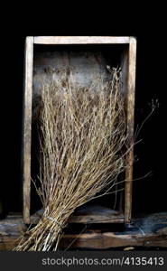 Stock photo: an image of a broom of dry grass in a wooden box