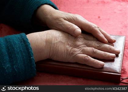 Stock photo: an image of old hands on a notebook