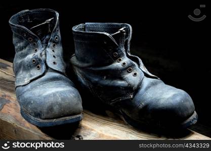 Stock photo: an image of very old black boots closeup