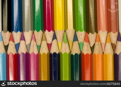 Stock photograph of brightly colored pencils forming aasymmetric pattern.