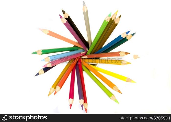 Stock photograph of brightly colored pencils forming aasymmetric pattern.