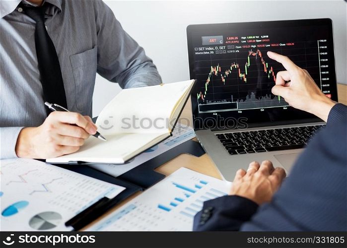 Stock traders looking at finance analysis marketing report trading stocks online in office