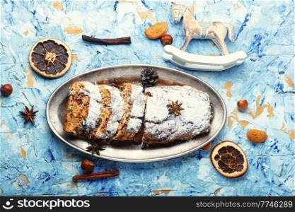 Stollen is a traditional German Christmas pastry. Christmas pastry. Christmas stollen and tree decorations