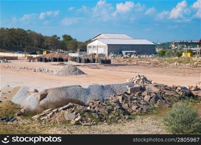 Stone and sand industry. Factory with constructions and warehouse.