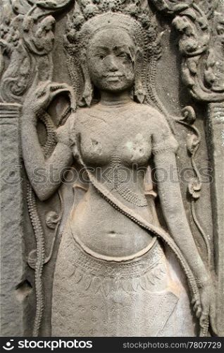 Stone apsara on the wall of Bayon temple in Angkor, Cambodia
