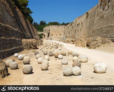 Stone balls between walls of Rhodes old town, Greece.