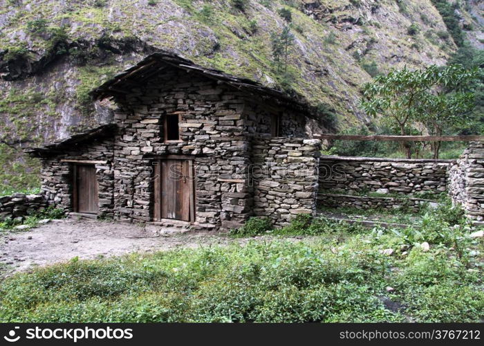 Stone barn near farm house in mountain, Nepal