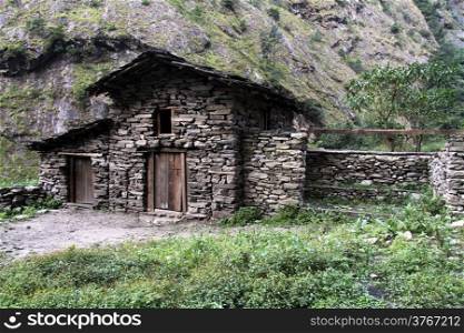 Stone barn near farm house in mountain, Nepal