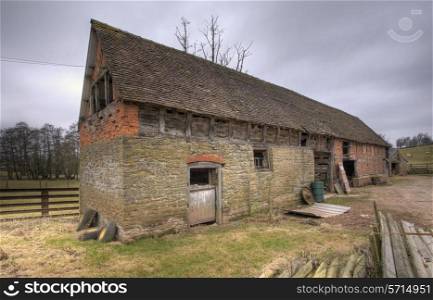 Stone barn with traditional wattle infill panels, Shropshire, England.