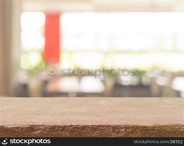 Stone board empty table top on of blurred background. Perspective brown stone over blur in coffee shop background - can be used mock up for montage products display or design key visual layout.