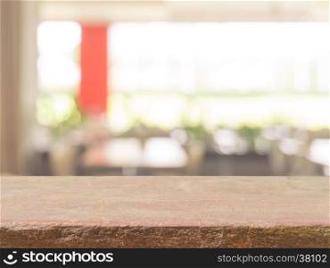 Stone board empty table top on of blurred background. Perspective brown stone over blur in coffee shop background - can be used mock up for montage products display or design key visual layout.