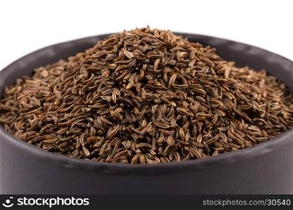 Stone bowl and pile of cumin seeds isolated on white background