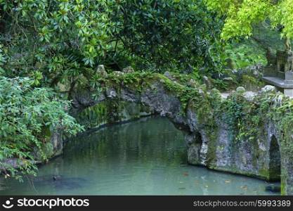 Stone bridge and pool in Quinta da Regaleira, Sintra, Portugal&#xA;