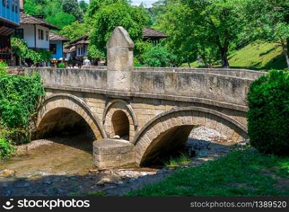 Stone bridge in the Etar Architectural Ethnographic Complex in Bulgaria on a sunny summer day. Etar Architectural Ethnographic Complex in Bulgaria