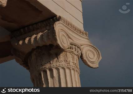 Stone carved column of an ancient historical building in Athens, Greece