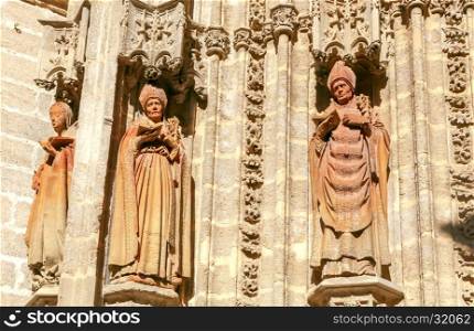 Stone carving and sculptures on the walls of the cathedral in Seville.. Sevilla. Sculptures on Cathedral.