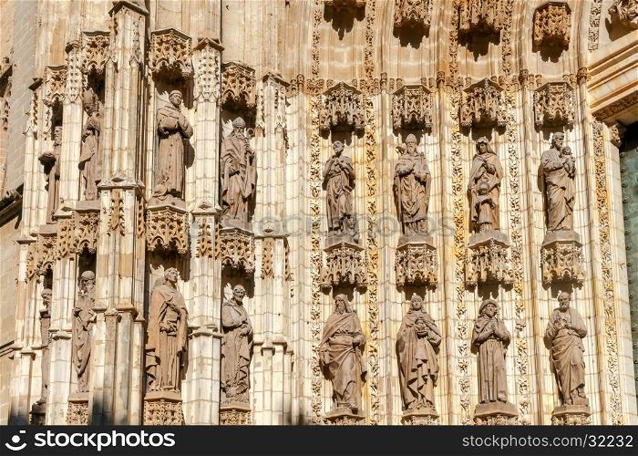 Stone carving and sculptures on the walls of the cathedral in Seville.. Sevilla. Sculptures on Cathedral.