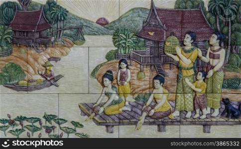 Stone carving of traditional Thai rural culture life in the past on temple wall at Wat Pho in Bangkok, Thailand