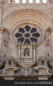 Stone carvings and window above main entrance to the old Cathedral or Se in Porto. Window above main entrance to the Porto Cathedral