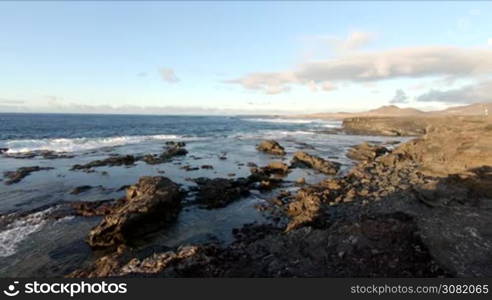 Stone cliffs, ocean waves and oceanscape. Punta jandia, Fuertaventura, Spain