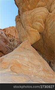 Stone column in shape of hourglass in desert