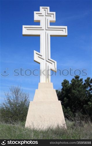 Stone cross on a background of blue sky&#xA;