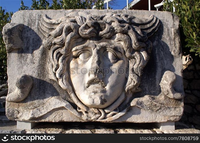 Stone face of man on ruins of Apollo temple, Didim